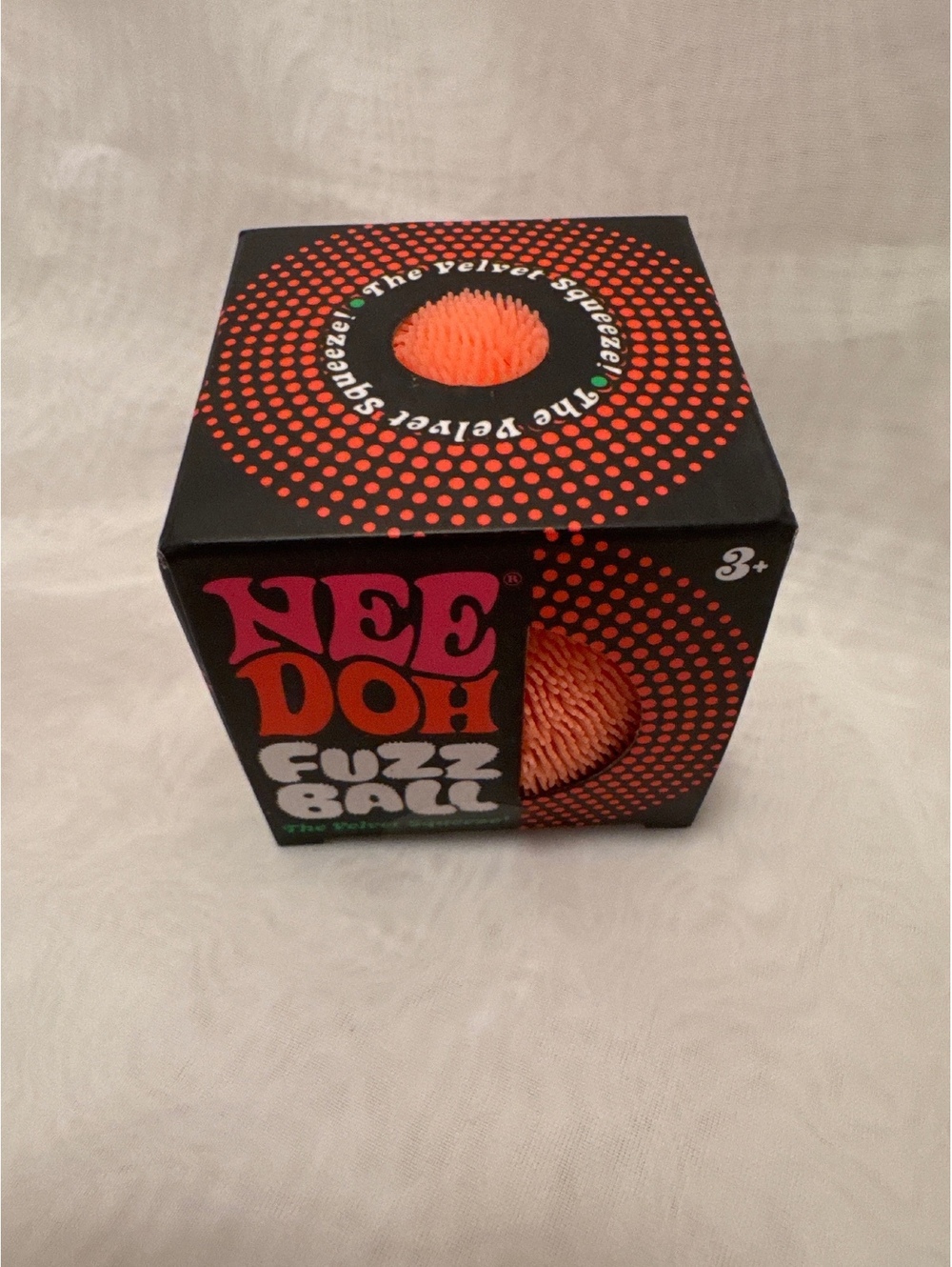 Schylling NeeDoh Fuzz Ball Orange stress ball